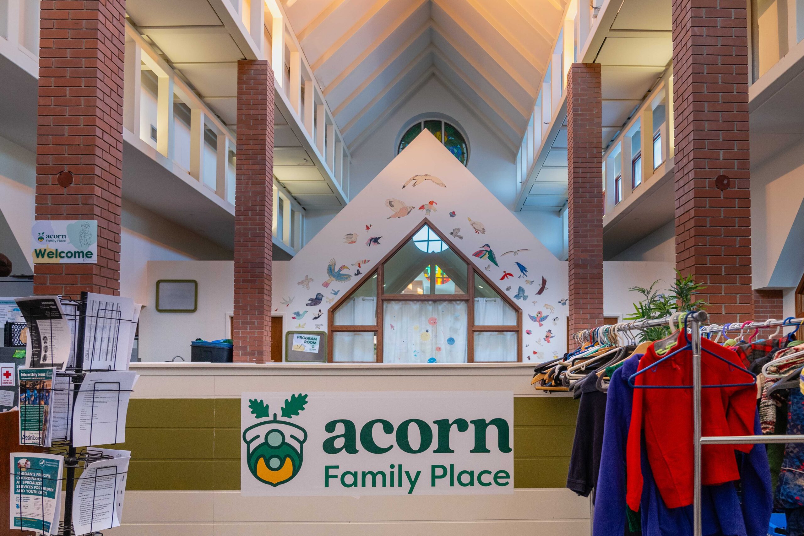 The lobby at Acorn Family Place is bright and cheerful, with a rack of donated clothing available for folks as soon as you walk in.