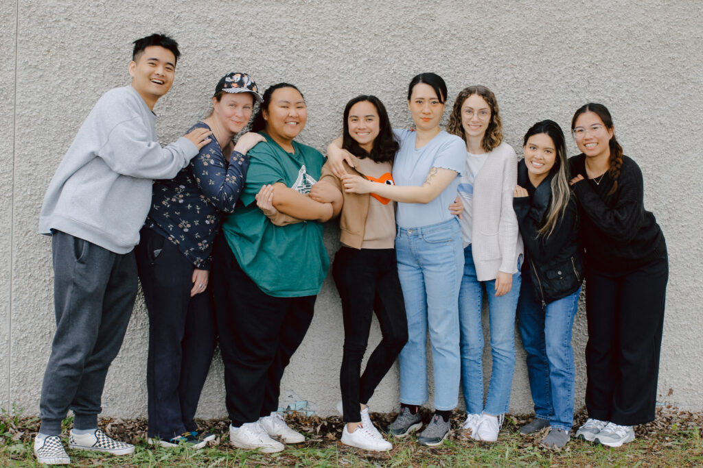 Aimee Pan embraces a co-worker, surrounded by a caring team from NorWest.